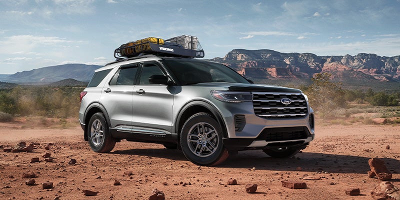 side angle of the front end of a 2025 Ford Explorer on a dirt road