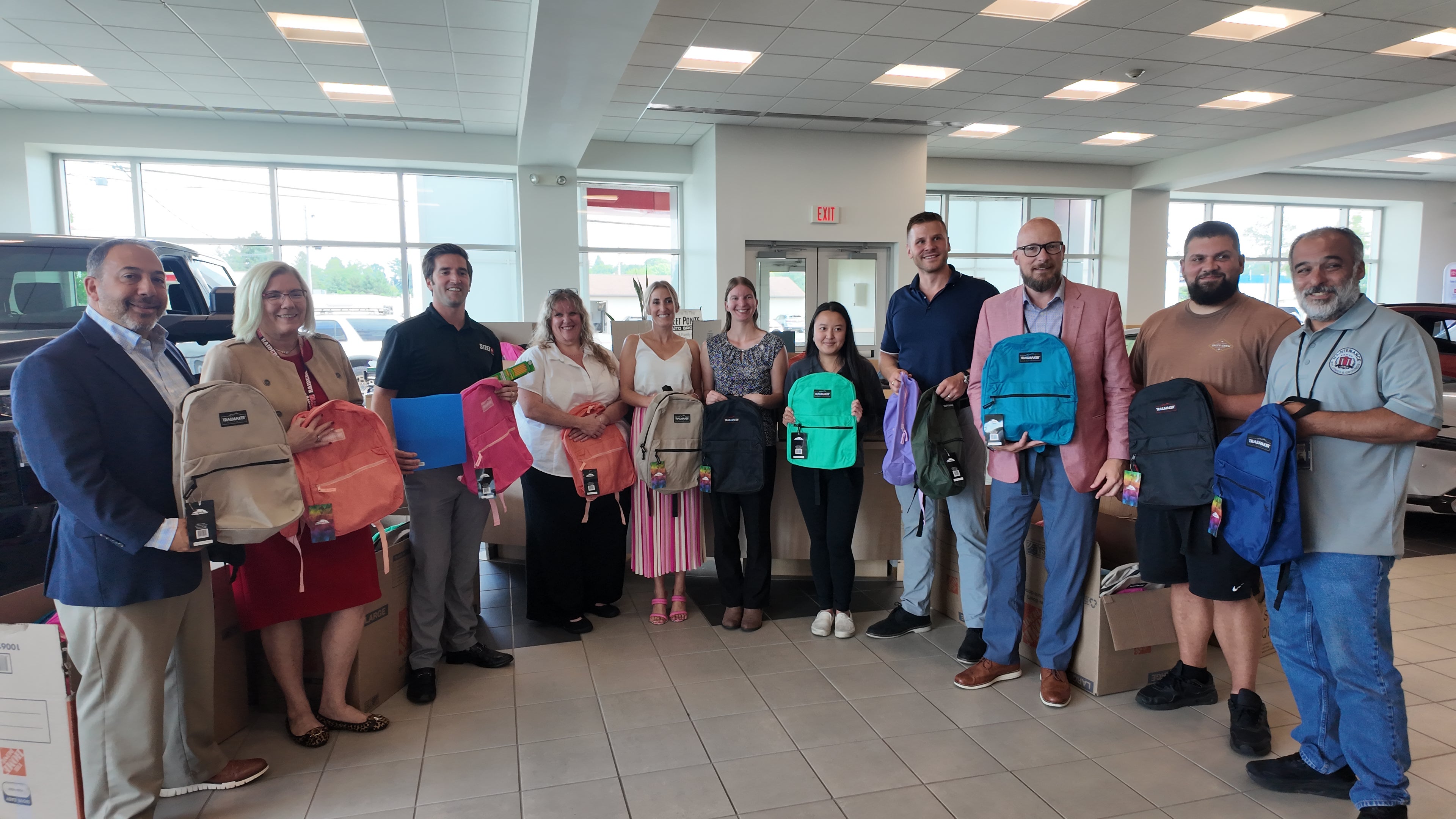 Steet Ponte Auto Group Presenting Utica Schools with Backpacks